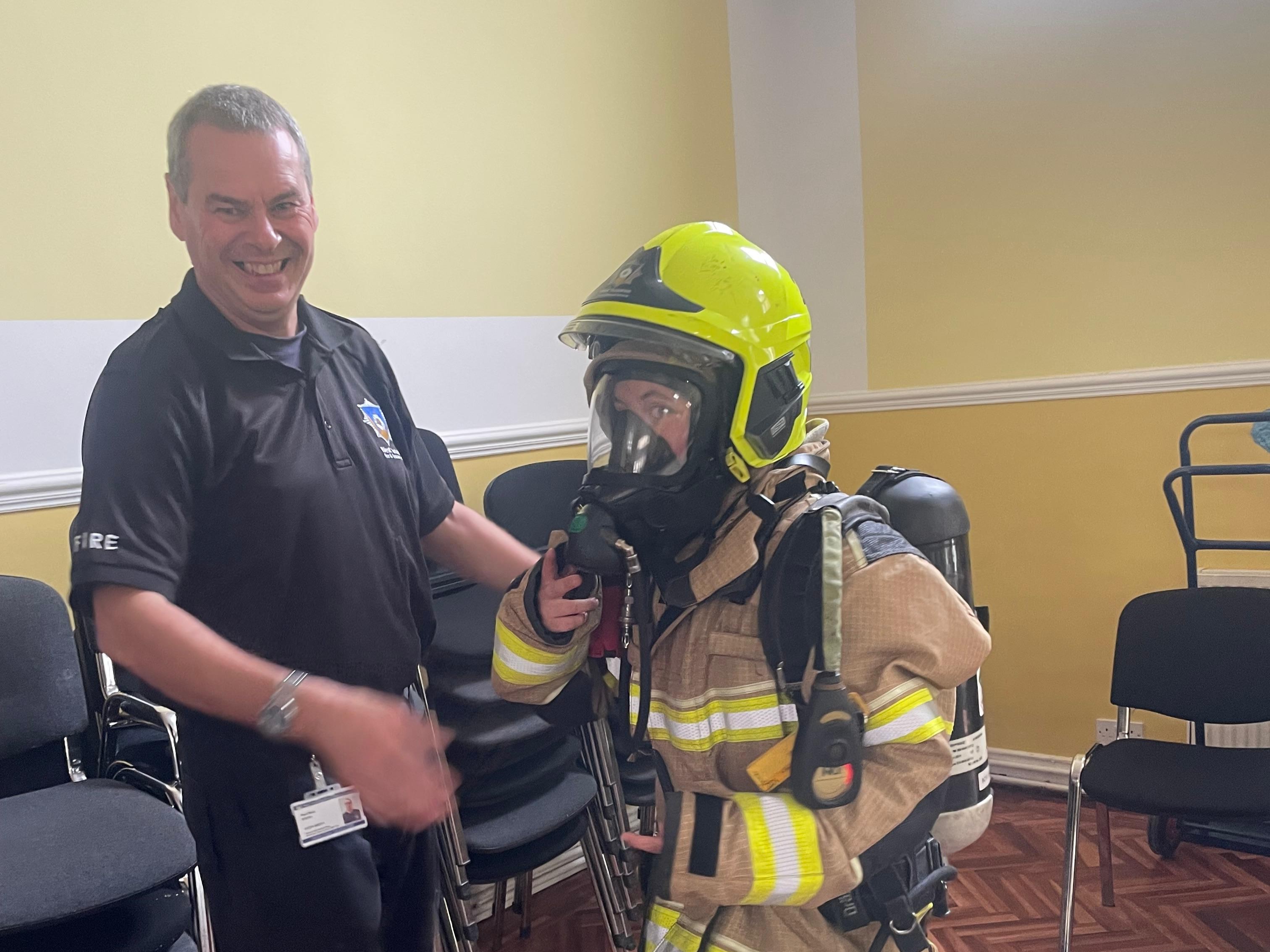 Photo of a firefighter with a Polish Saturday School pupil