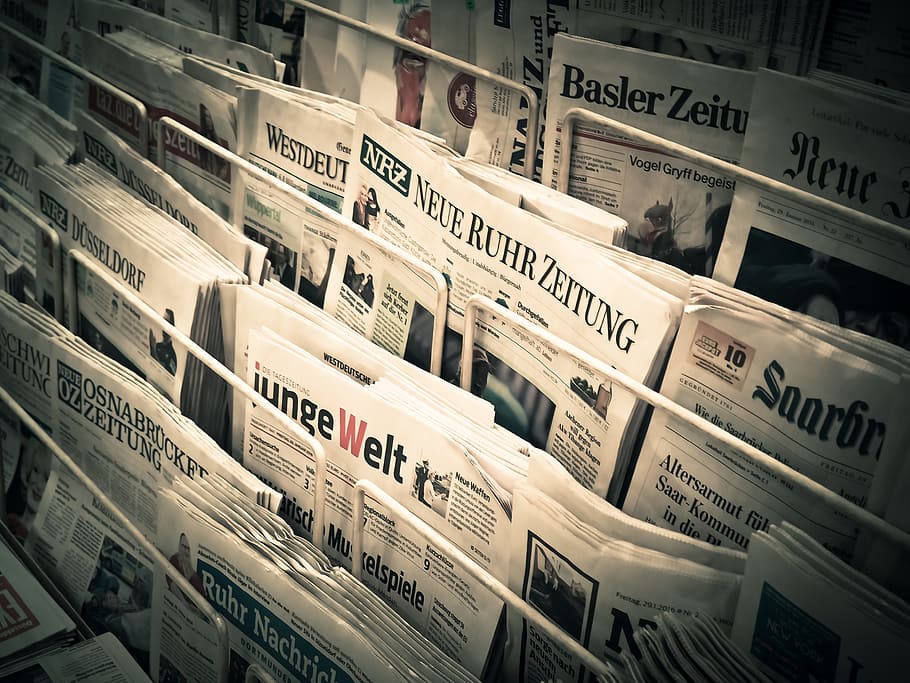 A photo showing newspapers, implying a news section on the website